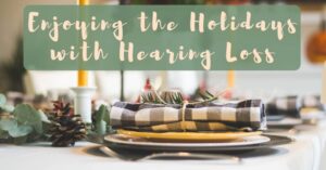 Festive holiday place setting for a table, with banner "Enjoying the Holidays with Hearing Loss".