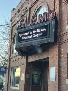 Sign outside Alamo Theater showing "Sponsored by the HLAA Downeast Chapter".